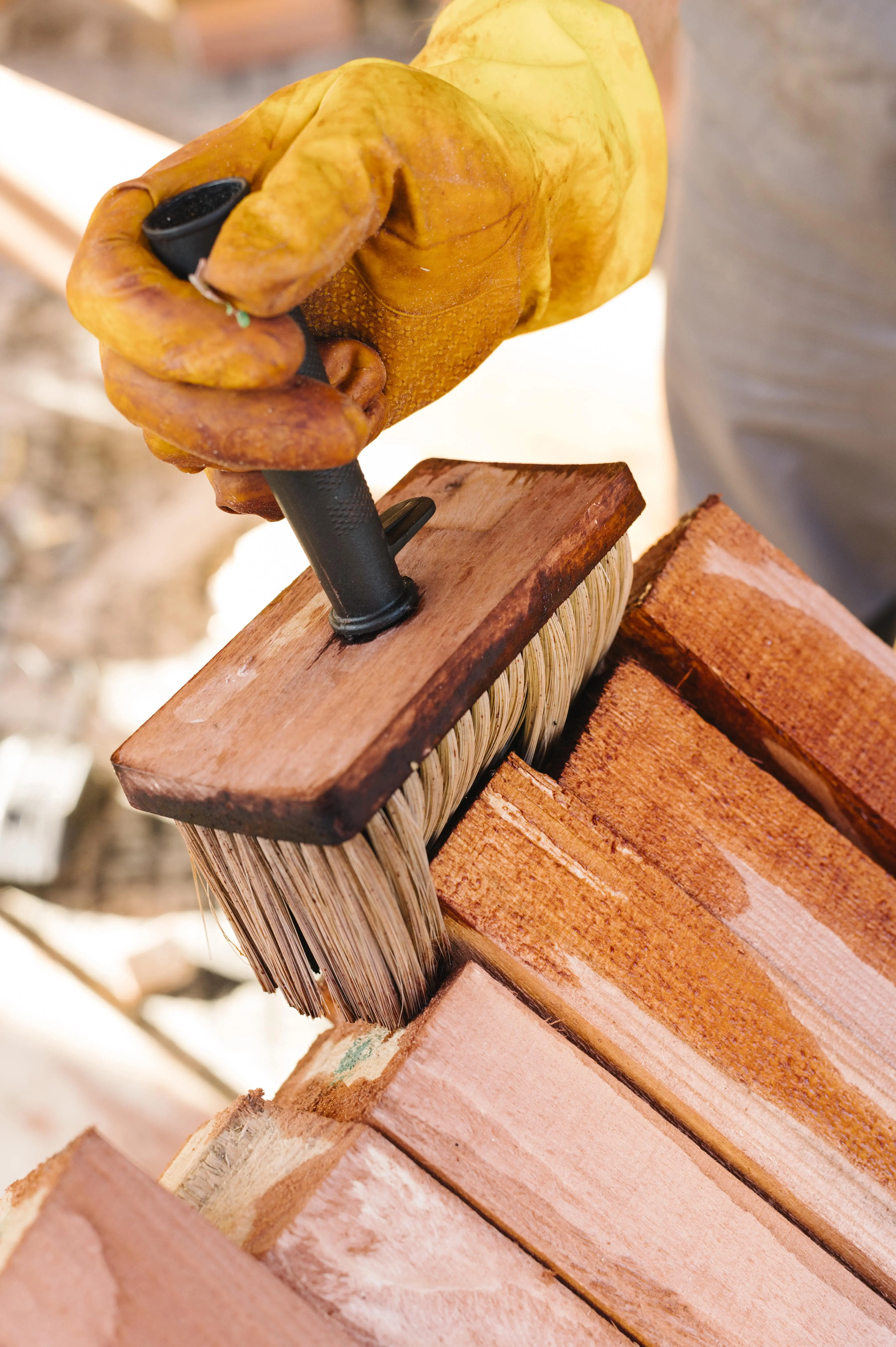 a person using a brush to brush wood person-varnishing-wood